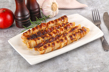 Grilled meat sausages wrapped bacon