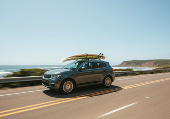 SUV with Surfboards Driving on Coastal Highway
