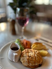 Sunday Roast Wellington in table with a glass of winw