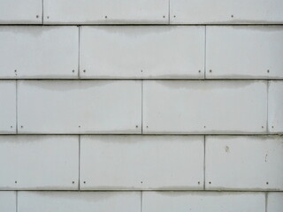 Gray fiber cement shingles as facade cladding. Ideal for textures, structures, and designs with modern, weather-resistant elements