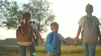 Happy children walk in nature on an adventure. Sunlight shining as Happy children explore outdoors. Happy group bonding in scenic surroundings. Happy Children enjoying nature and adventure together.