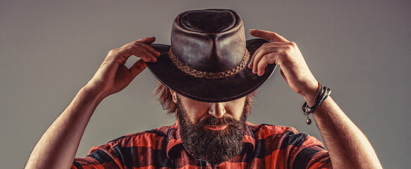 Man with gray beard wearing a cowboy hat. American cowboy. Portrait of young man wearing cowboy...