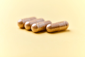 Carnitine capsules. Concept for a healthy dietary supplementation. Bright paper background. Soft focus. Close up.