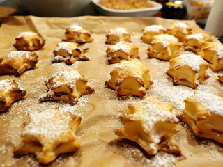 Baked puff pastry cookies with apple filling shaped like Christmas stars, a delicious and popular treat, perfect for holidays and festive occasions.