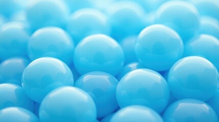 Close-up of many shiny light blue spheres in a pile