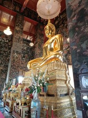 Wat Suthat is a beautiful temple and tourist attraction in Thailand. It has a beautiful golden Buddha and artistic paintings on the walls and ceilings.
