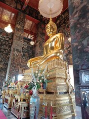 Wat Suthat is a beautiful temple and tourist attraction in Thailand. It has a beautiful golden Buddha and artistic paintings on the walls and ceilings.
