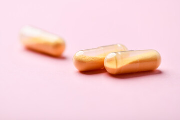 Coenzyme Q10 capsules. Antioxidants. Concept for a healthy dietary supplementation. Bright paper background. Soft focus. Close up. Copy space.