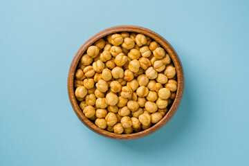 Top view of yellow roasted chickpeas in wooden bowl