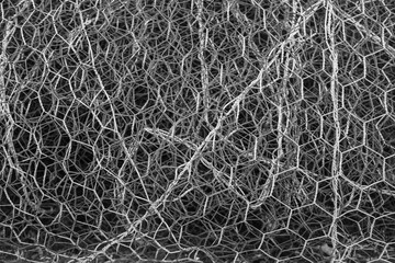 rusty scrap metal background. texture of the metal mesh. Torn, destroyed, broken metal mesh. iron background. twisted wire.