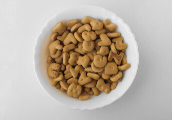 white plate full of cookies, a traditional treat associated with the festival of Saint Nicholas Sinterklaas in Belgium, Holland. table background and empty copy space.  in the form of letter digits