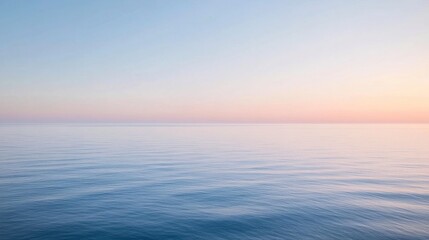 Obraz premium Serene pastel sunset over calm ocean water.