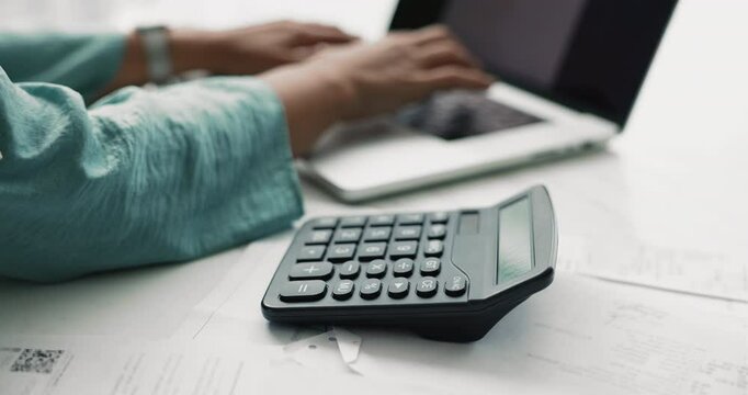 Close up female hands using modern laptop and calculator for own or company finances management, doing analysis, tracking monthly incomes and expenses, cropped view. Savings, investments, and taxes