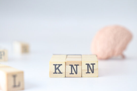knn acronym for mental health written on wooden cubes on a white background with copy space for text. 