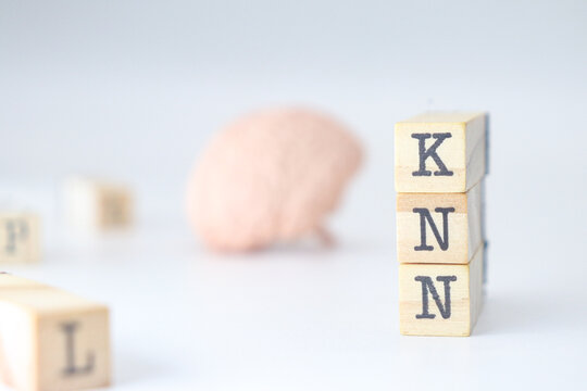 knn acronym for mental health written on wooden cubes on a white background with copy space for text. 