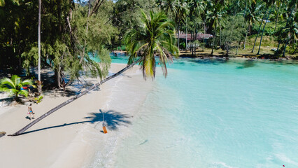 Discover the serene beauty of Koh Kood Thailand with its crystal-clear waters and lush palm trees