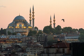 Suleymaniye Mosque at sunset with cityscape.