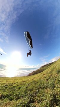 Extreme paragliding soaring in the coast of New Zealand. Adventure concept