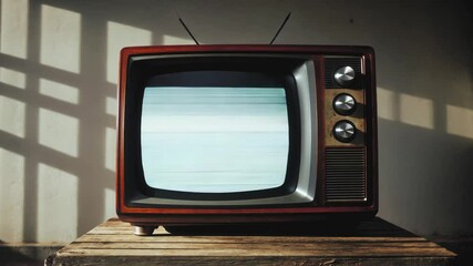 Vintage television casts eerie glow in shadowy room. Window light creates dramatic patterns on wall. Retro brown TV with analog static noise screen evokes nostalgic yet unsettling atmosphere.
