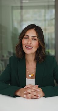 Attractive Mexican elegant businesslady lead online briefing event for staff, makes speech, provide information, plan or strategy, having digital communication through video call apps, vertical view