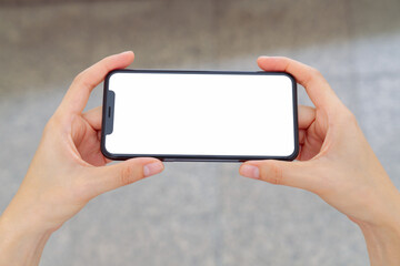 Hand holding smartphone mockup of blank screen, Take your screen to put on advertising.