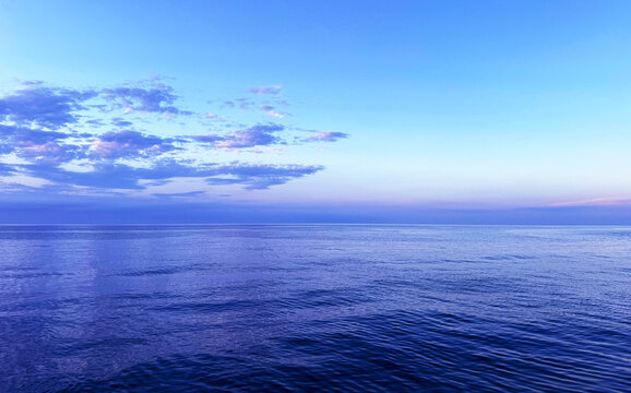 Ocean calm water and cloudy sky in the evening.