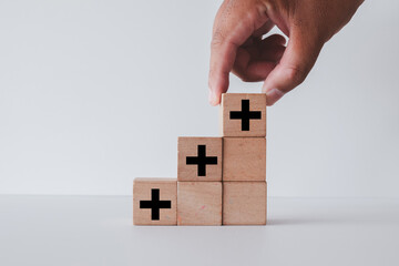 Positive Sign,growth mindset,opportunities,added value concept.,Hand arranging wooden cube with...