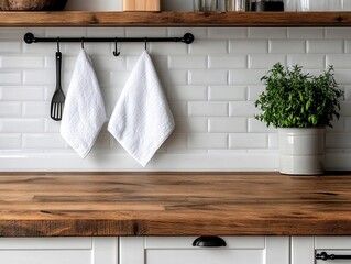 A kitchen counter top with two white towels hanging from it