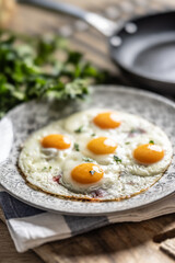 English breakfast on a plate. Ham and eggs sprinkled with parsley
