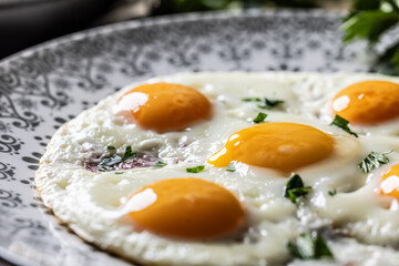 English breakfast on a plate. Ham and eggs sprinkled with parsley