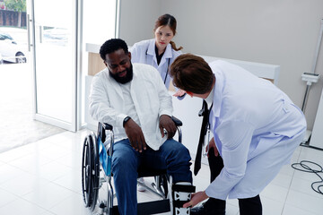 Doctors care for a patient with a broken leg in a wheelchair.
