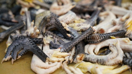 Fototapeta premium Raw Chicken Feet Displayed for Sale at a Local Marketplace