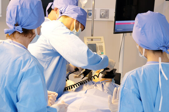 Male doctor using CPR in emergency room.