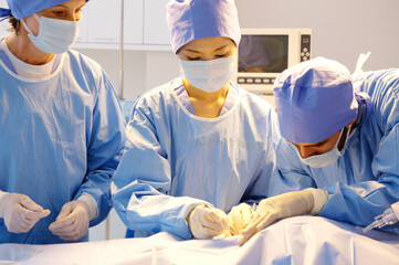 A team of doctors perform surgery on a patient in an operating room.