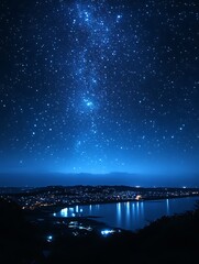Night sky, stars, Milky Way over coastal town.
