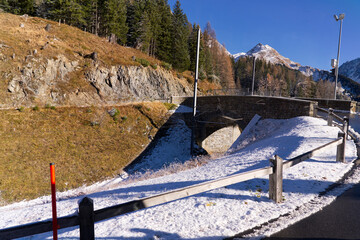 Scenic landscape at Swiss mountain pass Albula with snow and track of narrow gauge railway on a...