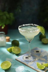 A glass with margarita cocktail with lime	