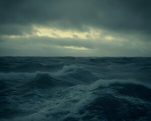 Fototapeta premium Dramatic stormy sea, dark ocean waves crashing under a brooding sky. Perfect for illustrating concepts of power, nature, or uncertainty.
