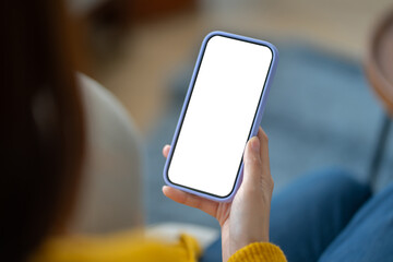 Close-up of business woman hand holding mobile phone with blank desktop screen in home...