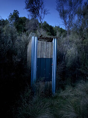 New Zealand long drop toilet or 'dunny' in the wilderness at night. At Kaimanawa Ranges, central North Island. Surrounded by Manuka and Beech trees.
