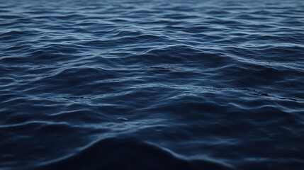 Obraz premium Dark blue ocean water with small waves.