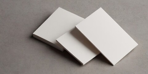Three white business cards are stacked on top of each other