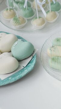delicious white and blue cakes and sweet desserts macaroons lie on the buffet. Banquet table at the event and holiday. Confectionery sweets close-up