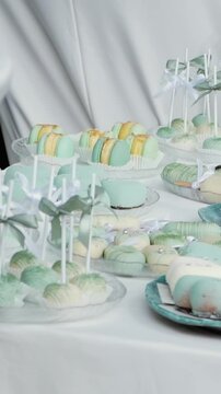 delicious white and blue cakes and sweet desserts macaroons lie on the buffet. Banquet table at the event and holiday. Confectionery sweets close-up