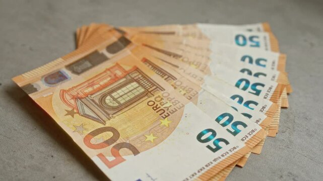 Euro banknotes fanned out on a concrete surface illustrate european currency emphasis on finance and economy within the european union setting