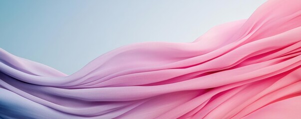 Pastel abstract background concept. A flowing wave of pink and blue fabric creating a dreamy abstract background.