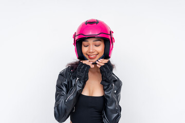 A pretty young asian woman in a pink motorcycle helmet and black jacket, smiling brightly while securing her chin strap.