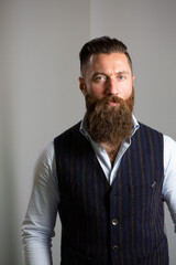 Portrait of confident bearded man wearing waistcoat and shirt