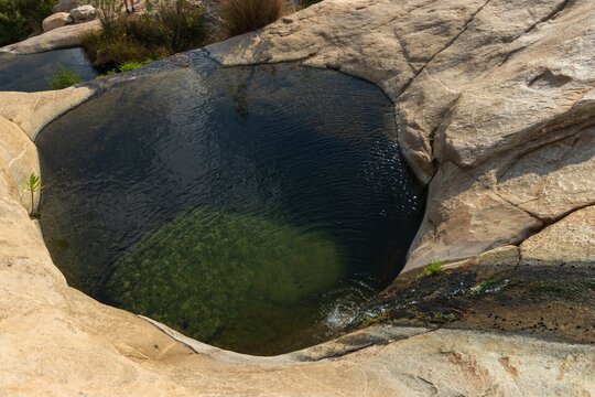 Natural infinity pool between rocks at a mountain creek.