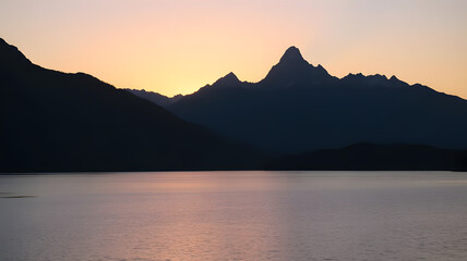 a majestic mountains during sunrise, featuring a calm lake in the foreground